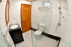 a small bathroom with a toilet and a sink at Mirage Kings Cottage in Nuwara Eliya