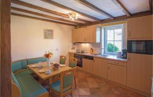 a kitchen with a table and chairs and a dining room at Haus Engel-uriel in Steffeshausen