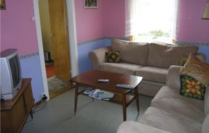 a living room with a couch and a table at Gunhildhus in Vangsnes