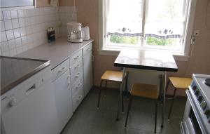 a kitchen with a counter and a table and a window at Gunhildhus in Vangsnes