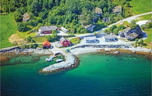 an aerial view of a house next to the water at Beautiful Home In Omastrand With Wifi in Oma