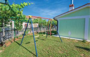 a playground with swings in a yard at Stunning Home In Kapelica With Wifi in Raša