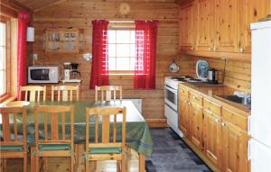 a kitchen with a table and chairs in a cabin at Beautiful Home In Omastrand With Wifi in Oma