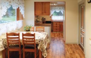 a kitchen with a table and chairs in a room at Lovely Home In Sveio With Wifi in Sveio