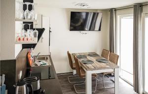 a kitchen and dining room with a table and chairs at Beautiful Apartment In Graal-Müritz in Graal-Müritz +6 photos