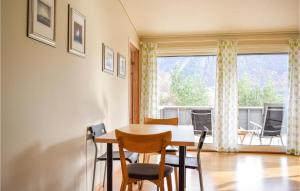 a dining room with a table and chairs and a window at 3 Bedroom Cozy Home In Forsand in Jørpeland