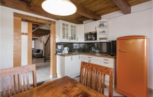a kitchen with a refrigerator and a table with chairs at Haus In Gaas Mit Panoramablick in Gaas