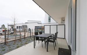 a table and chairs on the balcony of a house at Highend Travemünde - Whg 09 in Travemünde