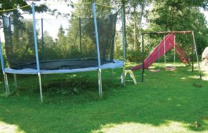 a playground with two swings and a slide at 3 Bedroom Stunning Home In Bodafors in Bodafors