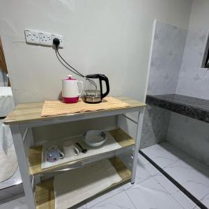 a small table with a coffee maker on it at Cabin in the Woods by Abris in Bukit Gambir