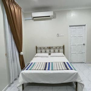 a bedroom with a bed and a air conditioner at Cabin in the Woods by Abris in Bukit Gambir