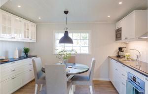 a kitchen with a table and chairs and a dining room at Amazing Home In Fgelmara With Wifi in Fågelmara