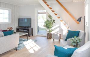 a living room with a staircase and a tv at Amazing Home In Fgelmara With Wifi in Fågelmara