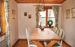 a dining room with a wooden table and chairs at Awesome Home In Skillingaryd With 3 Bedrooms And Sauna in Södra Nässja