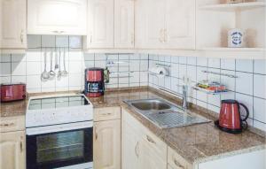 a kitchen with white cabinets and a sink at Pet Friendly Apartment In Freiberg in Freiberg