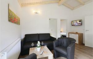 ein Wohnzimmer mit einer Couch und zwei Stühlen und einem Tisch in der Unterkunft Ferienhausdorf Thale in Thale