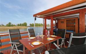 a wooden table on the back of a boat at 2 Bedroom Beautiful Ship In Radewege in Radewege