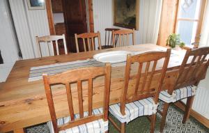 a dining room table with chairs and a wooden table and chairsktop at Holiday Home Vätinge Mellangård Tranås in Gripenberg
