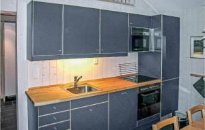 a kitchen with a sink and a microwave at Holiday Home Gålå Peer Gyntlia Iii in Gålå