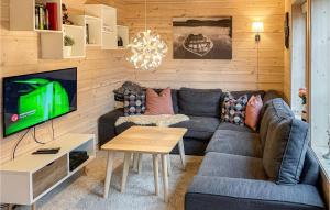 uma sala de estar com um sofá e uma televisão em Cozy Home In Vikes With House A Mountain View em Vikeså