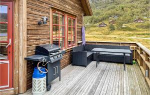 a grill and a bench on a porch of a cabin at Cozy Home In Vikes With House A Mountain View in Vikeså