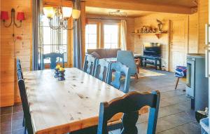 a dining room with a wooden table and chairs at Amazing Home In seral With 4 Bedrooms And Sauna in Ljosland