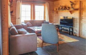 a living room with a couch and a television at Amazing Home In seral With 4 Bedrooms And Sauna in Ljosland