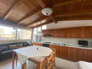 a kitchen with a table and a dining room at B&B Volì Club in Siderno Marina