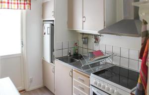 a small kitchen with a sink and a stove at Beautiful Home In Tived With Kitchen in Tived