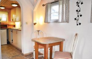 a kitchen with a table and two chairs and a window at Stunning Home In Lärbro With Wifi in Lärbro