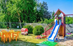a small backyard with a playground with a slide at Beautiful Home In Dzwirzyno With 1 Bedrooms And Wifi in Dźwirzyno