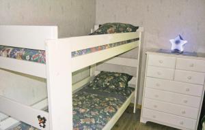 a bedroom with two bunk beds and a dresser at Beautiful Home In Bottnaryd With Kitchen in Bottnaryd