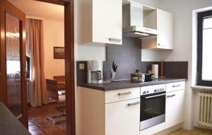 a kitchen with white cabinets and a stove top oven at Awesome Apartment In Hornberg With 2 Bedrooms And Wifi in Hornberg
