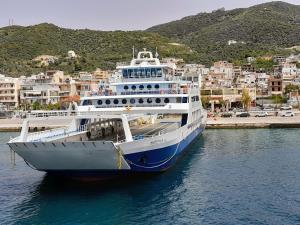 a cruise ship is docked in a harbor at Artemida in Loutra Edipsou