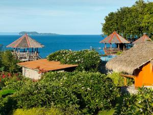 a view of a resort with the ocean in the background at Grandview Cottages Resort in Siaton