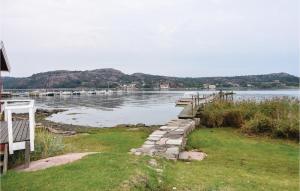 a body of water with a dock and boats in it at 2 Bedroom Lovely Home In Hamburgsund in Hamburgsund