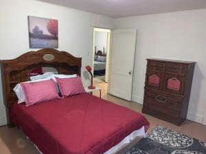 - une chambre avec un grand lit rouge et une commode dans l'établissement 3 bedroom one bathroom townhouse - 20B Elm street Charlton Heights WV 25040, à Glen Ferris