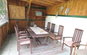 a wooden table and chairs on a patio at Amazing Apartment In Wagrain With 1 Bedrooms, Wifi And Outdoor Swimming Pool in Wagrain