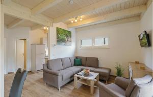 a living room with a couch and a table at Ferienhausdorf Thale in Thale