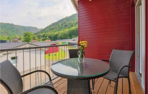 a table and chairs on a balcony with a view at Ferienhausdorf Thale in Thale