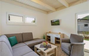 a living room with two couches and a table at Ferienhausdorf Thale in Thale +36 photos