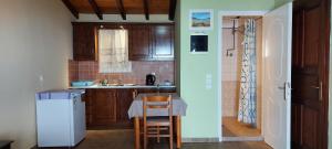 Una pequeña cocina con una mesa y un refrigerador. en BOHALI'S HOUSE, en Agios Gordios