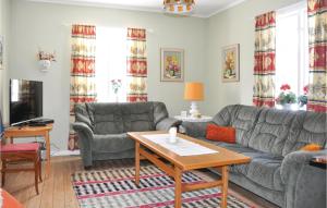 a living room with a couch and a table at Awesome Home In Ekshrad With 3 Bedrooms in Ekshärad
