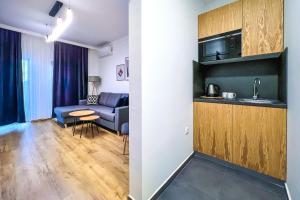 a living room with a couch and a table at Deluxe Central Rooms in Karlovo