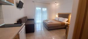a hotel room with a bed and a kitchen at Anatoli Studios in Skala Rachoniou