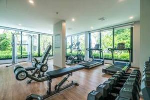 a gym with several treadmills and exercise bikes at Nayang Beach Brand New Executive Luxury Condo in Nai Yang Beach