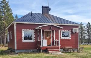 a red tiny house with a porch and a table at 2 Bedroom Gorgeous Home In Arvidsjaur in Arvidsjaur