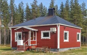 a red house with a black roof at Beautiful Home In Arvidsjaur With 2 Bedrooms, Sauna And Wifi in Arvidsjaur