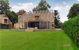 a wooden house with a lawn in front of it at Haus 8 in Wendorf