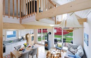a kitchen and living room with a wooden staircase at Annes Bootshaus Hafenblick in Berg